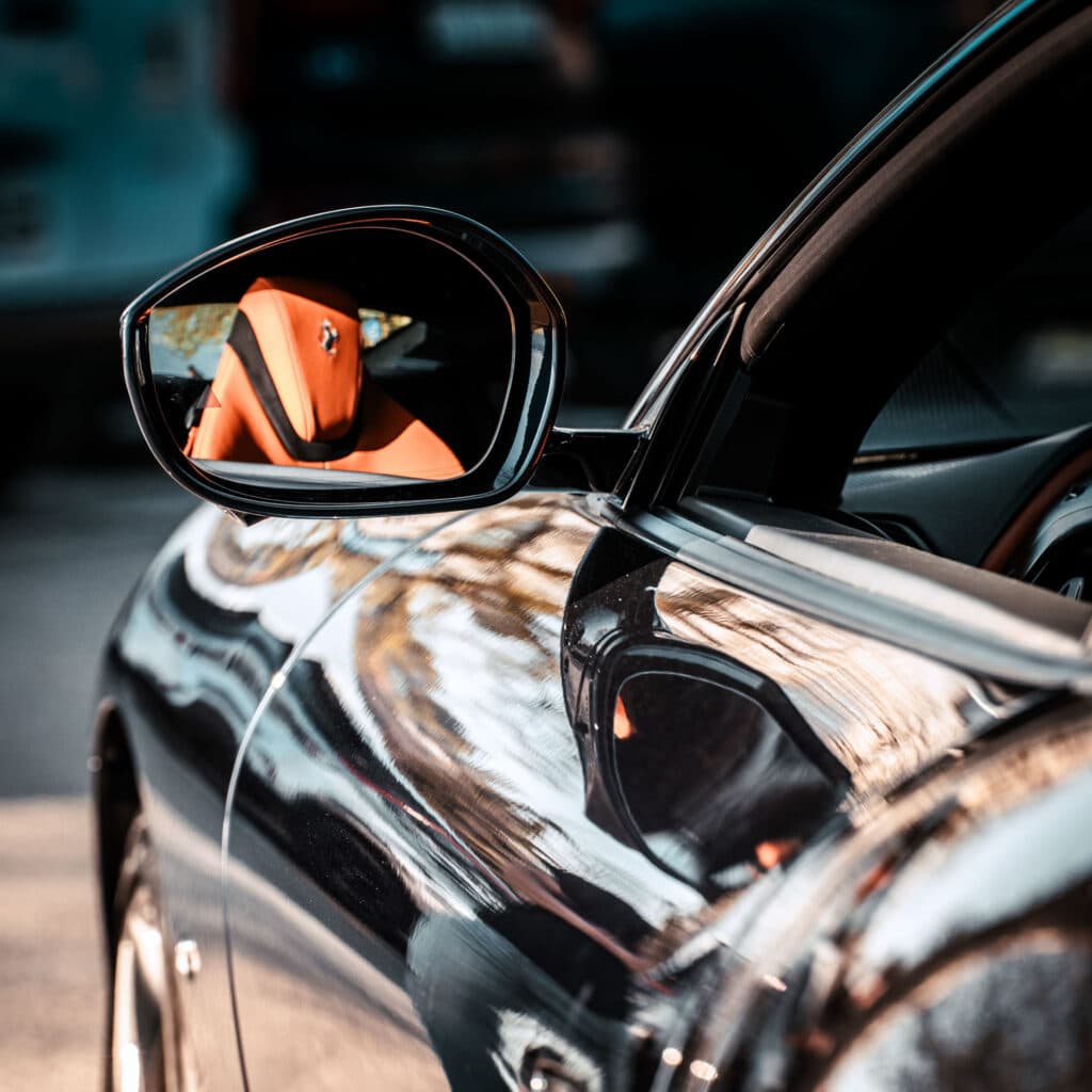 Brand photography Luxembourg: Ferrari side mirror body reflection detail