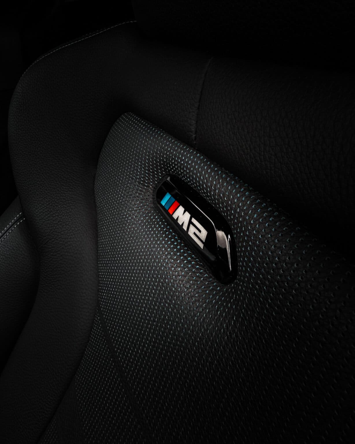Brand photography Luxembourg: BMW M2 badge seat detail automotive