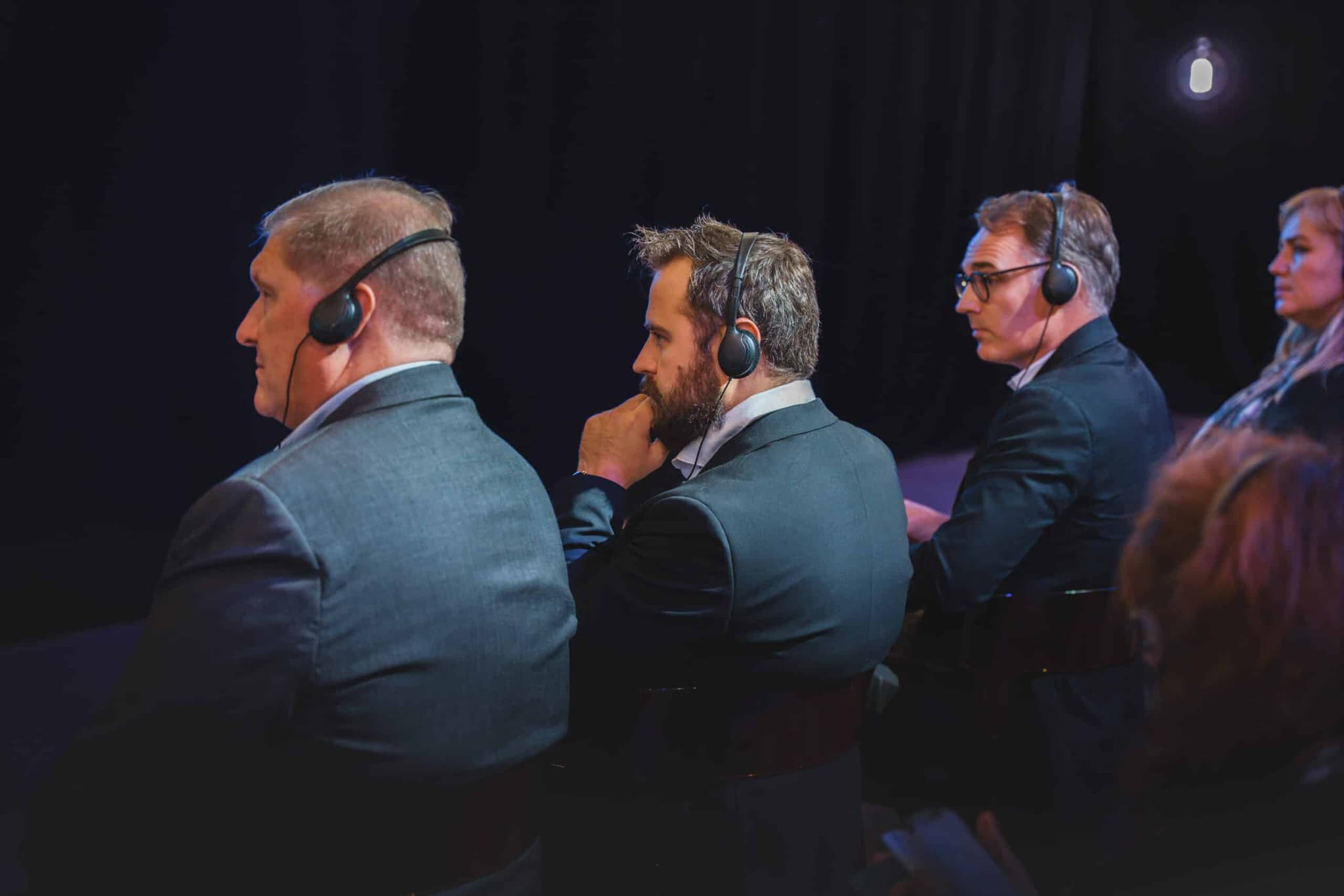 Event photographer Luxembourg: business conference delegates with headsets