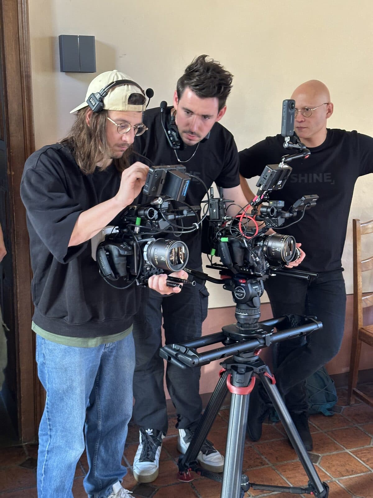 A production crew setting up a camera rig on location during a shoot